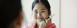 child holding a tooth brush