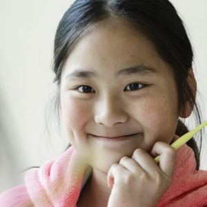 child holding a tooth brush