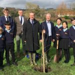 Group of students and teachers after planting a new tree