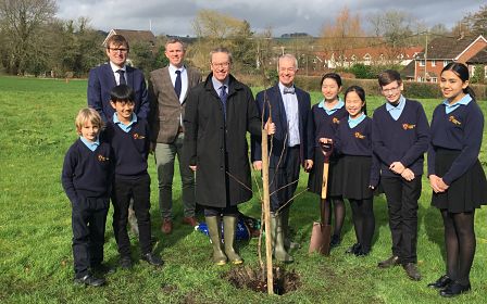 Group of students and teachers after planting a new tree