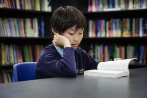 boy reading in a library
