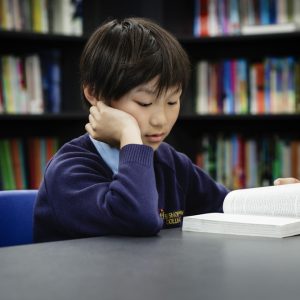 boy reading in a library