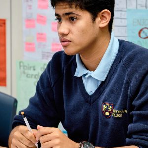 boy wearing uniform and learning