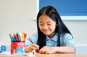 girl smiling as she works