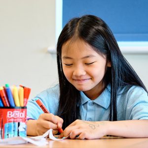 girl smiling as she works