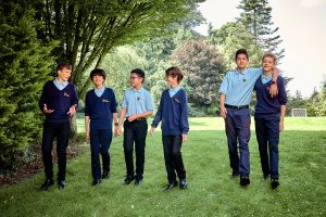 children standing underneath trees