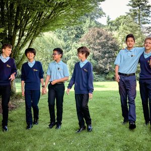 children standing underneath trees