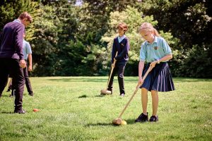 children holding sticks