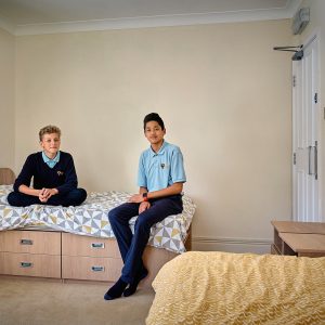 children sitting on a bed