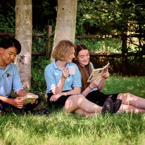 girls sitting on a field