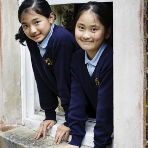 Girls Leaning on Window