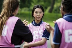 Girls wearing pink netball bibs