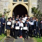 group of school boys holding certificates