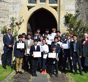 group of school boys holding certificates
