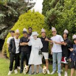 group of teenage boys with cutout of the queen